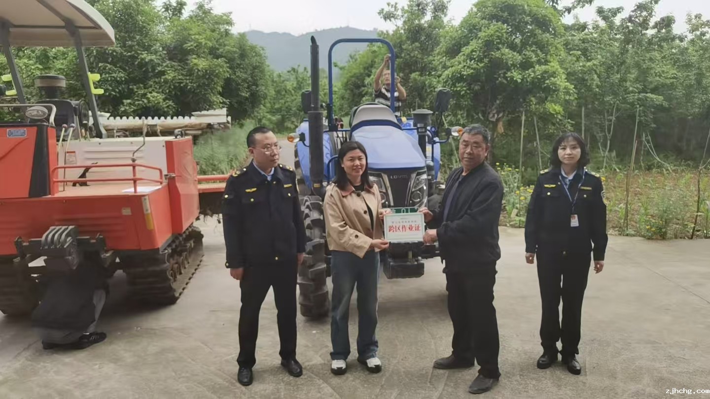 图2.左文清主任给农机负责人颁发农机跨区作业证.jpg